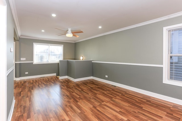 empty room featuring crown molding, dark hardwood / wood-style flooring, and ceiling fan