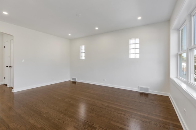 unfurnished room featuring dark wood-type flooring