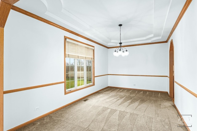 carpeted spare room with a notable chandelier, a raised ceiling, and crown molding