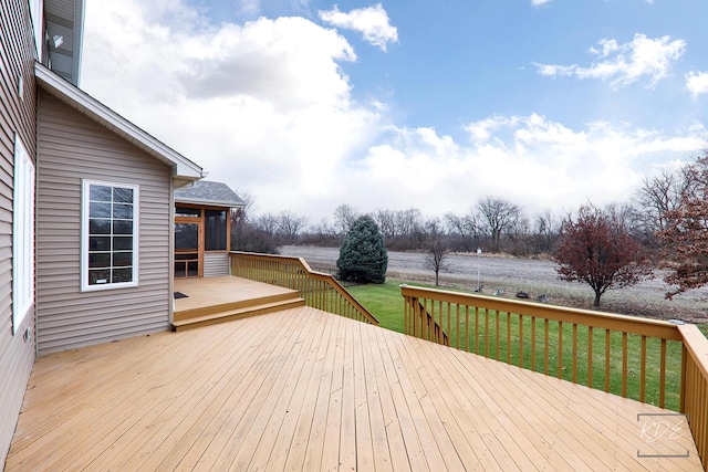 wooden deck with a yard and a sunroom