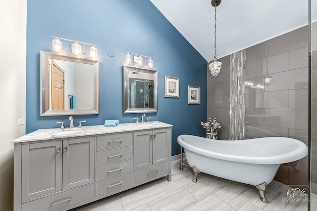 bathroom with plus walk in shower, vanity, and lofted ceiling