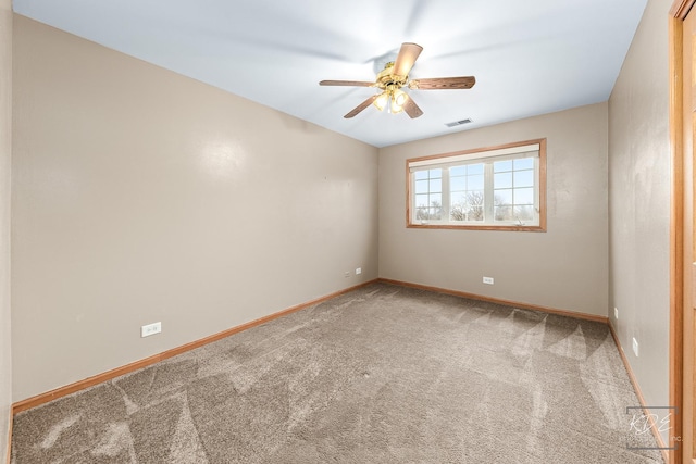 carpeted spare room with ceiling fan