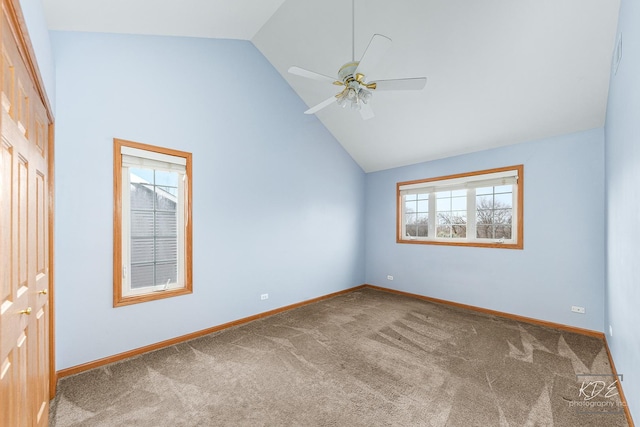 unfurnished room with ceiling fan, carpet floors, and high vaulted ceiling