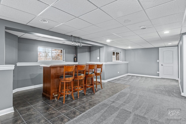 bar featuring a drop ceiling