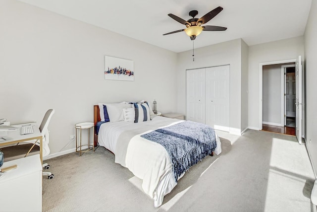 carpeted bedroom with ceiling fan and a closet