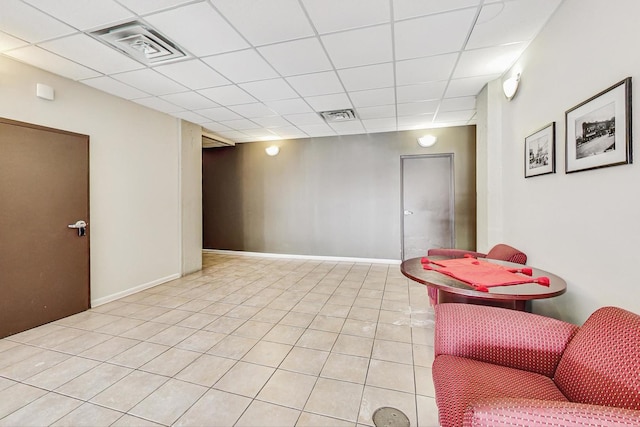 interior space featuring a drop ceiling and light tile patterned floors