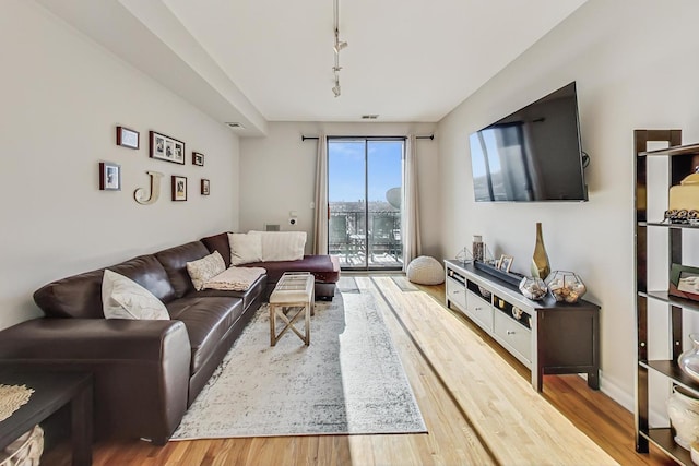 living room with track lighting and hardwood / wood-style floors