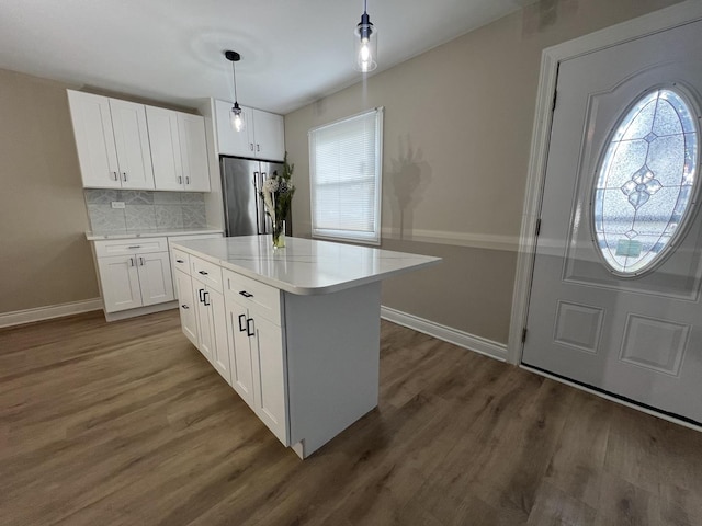 kitchen featuring white cabinets, dark hardwood / wood-style floors, stainless steel appliances, and tasteful backsplash