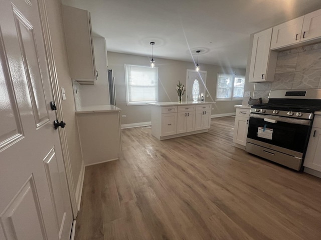 kitchen with appliances with stainless steel finishes, tasteful backsplash, white cabinetry, and hanging light fixtures