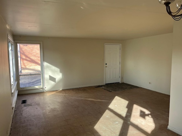 spare room featuring a chandelier