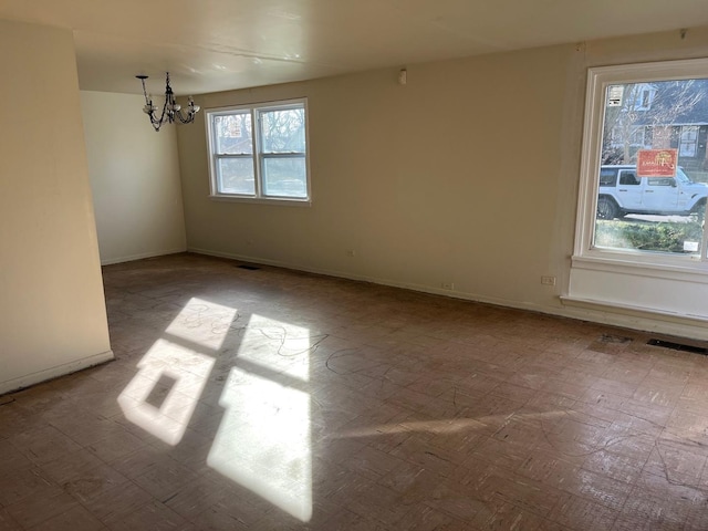 empty room featuring a chandelier