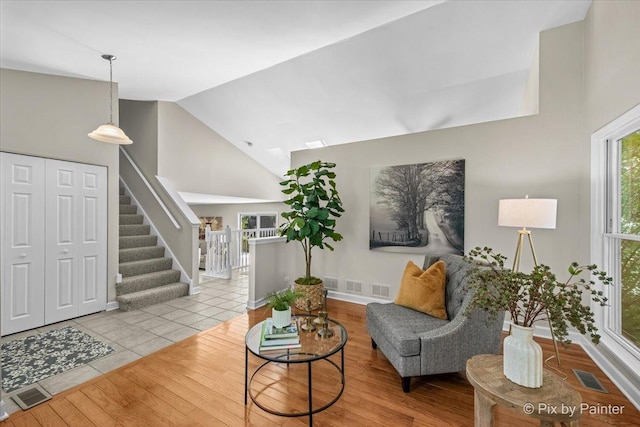 1154 Dovercliff Way, Crystal Lake, IL 60014 - living area featuring high vaulted ceiling, stairs, and wood finished floors