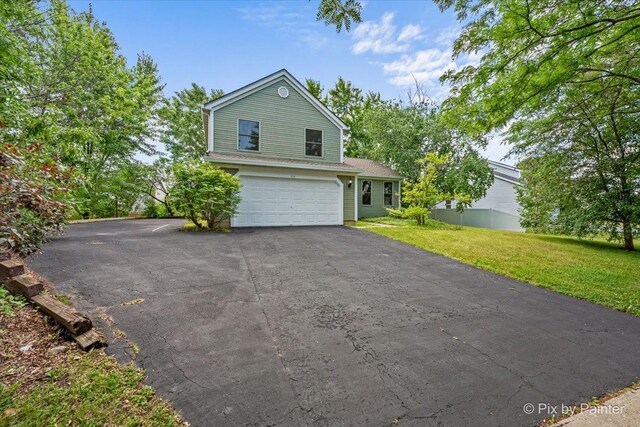 1154 Dovercliff Way, Crystal Lake, IL 60014 - view of side of home with asphalt driveway, a garage, and a lawn