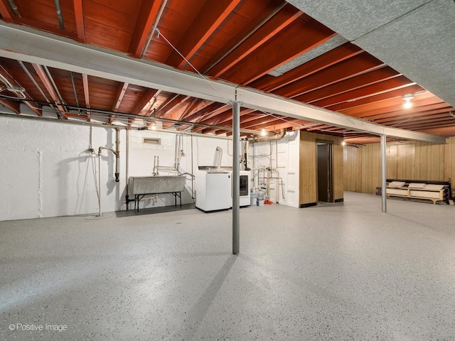 basement featuring washer and dryer and sink