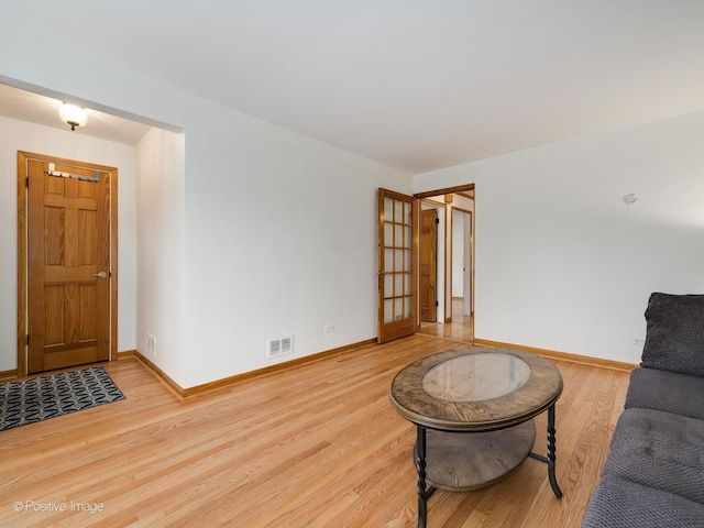 living room with light hardwood / wood-style flooring