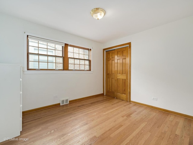 spare room with light hardwood / wood-style floors