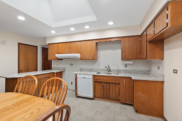 kitchen featuring white dishwasher, backsplash, kitchen peninsula, and sink