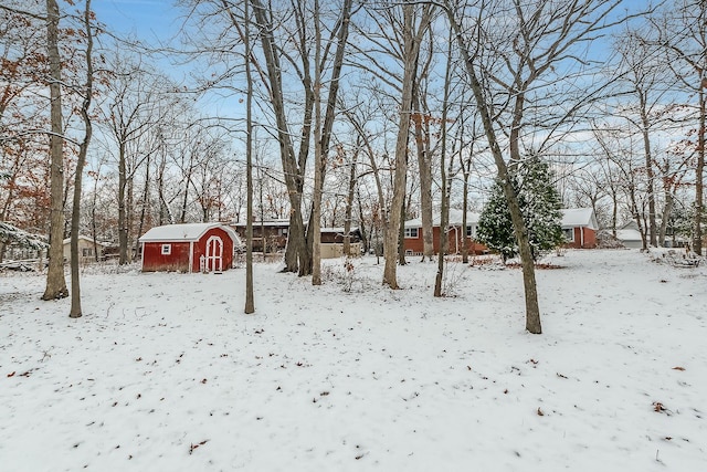 snowy yard with an outbuilding