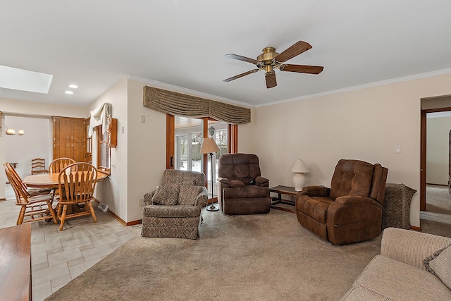 living room featuring a skylight, ceiling fan, light colored carpet, and ornamental molding