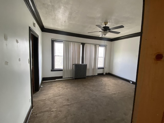 carpeted empty room featuring ceiling fan, radiator heating unit, and ornamental molding