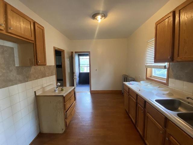 kitchen featuring wood-type flooring, plenty of natural light, and sink