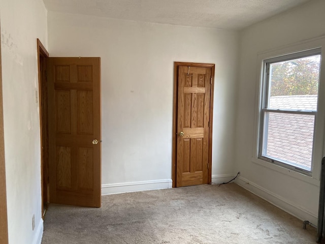 unfurnished bedroom featuring carpet and a textured ceiling