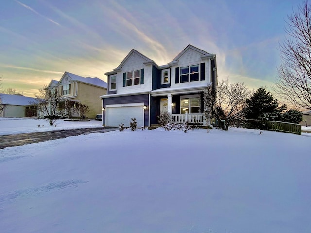 view of front of property with covered porch and a garage