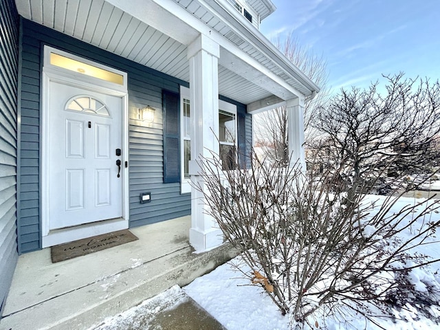 view of snow covered property entrance