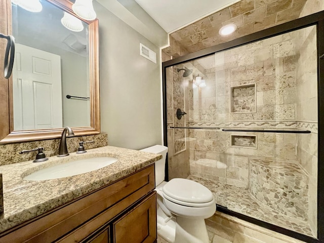 bathroom with vanity, toilet, and walk in shower