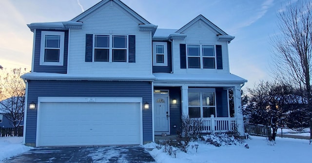 view of property with a porch and a garage