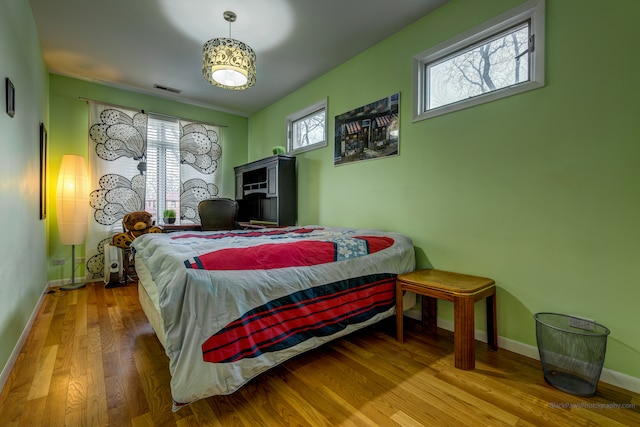 bedroom with hardwood / wood-style flooring