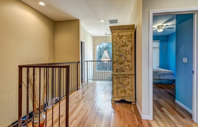 corridor with hardwood / wood-style floors