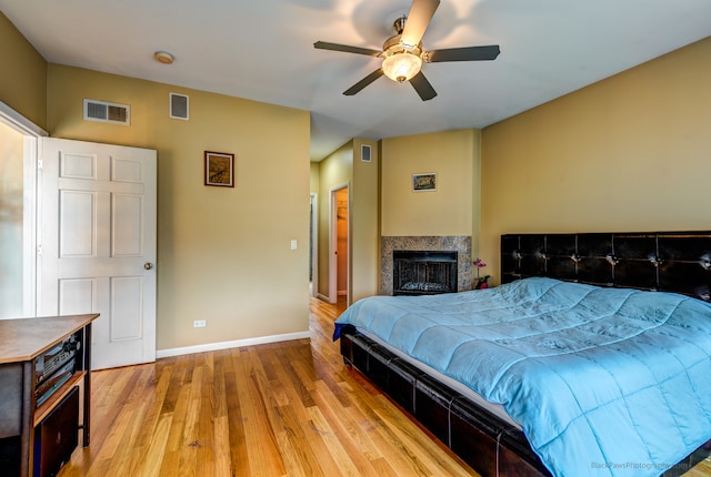 bedroom with hardwood / wood-style floors and ceiling fan