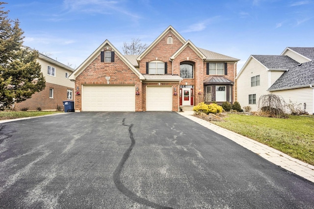 view of front property featuring a front yard and a garage