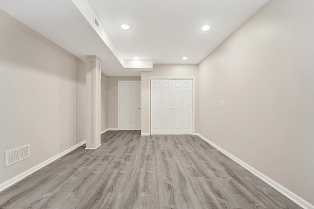 basement with light hardwood / wood-style floors