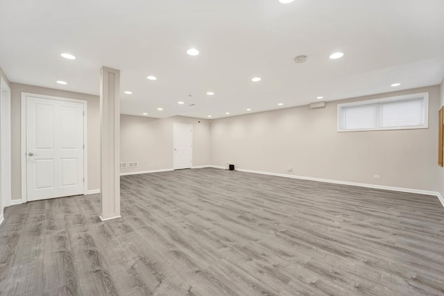 basement with light hardwood / wood-style flooring