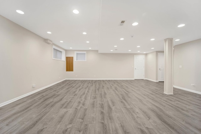 basement with light hardwood / wood-style floors