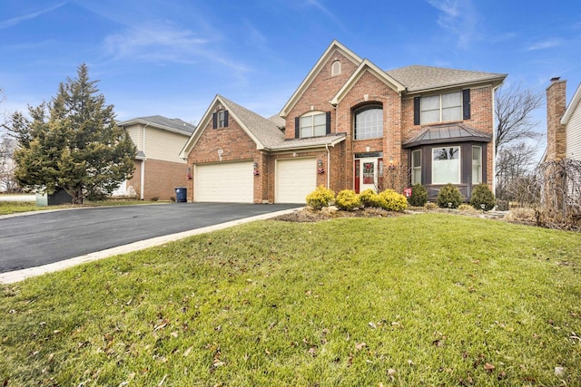 view of front property with a garage and a front lawn