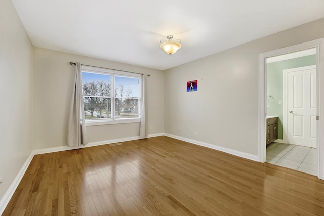 spare room featuring light wood-type flooring