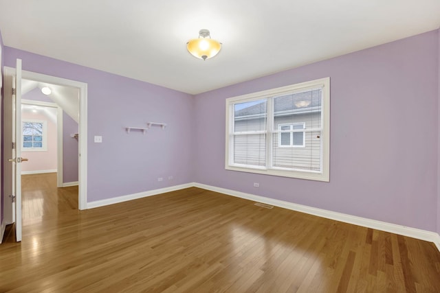 unfurnished room with wood-type flooring