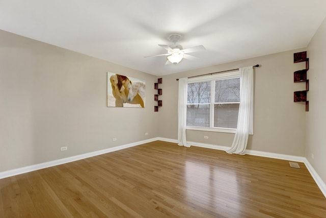 empty room featuring hardwood / wood-style floors and ceiling fan