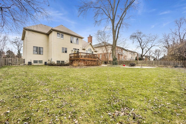 view of yard featuring cooling unit and a deck