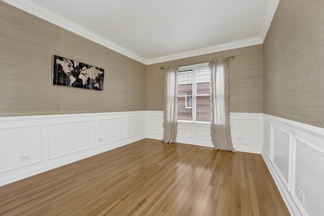 unfurnished room featuring light hardwood / wood-style floors and crown molding