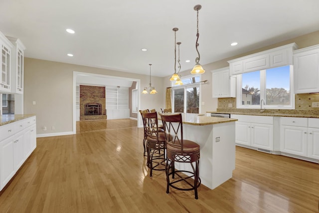 kitchen featuring white cabinets and light stone countertops