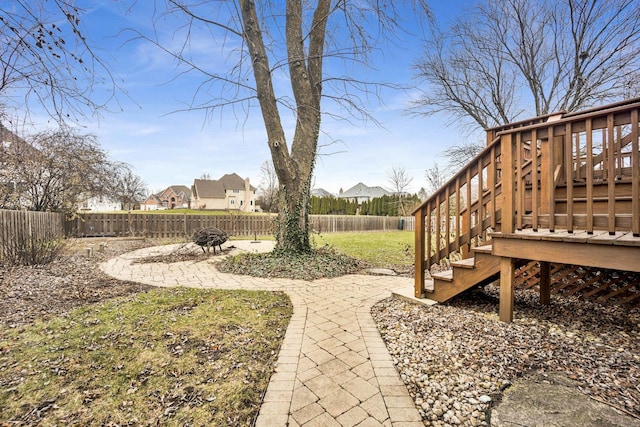 view of yard with an outdoor fire pit, a patio area, and a wooden deck