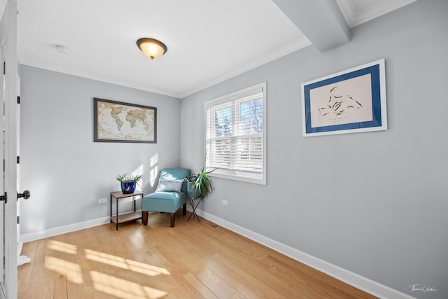 sitting room featuring hardwood / wood-style flooring, crown molding, and beamed ceiling