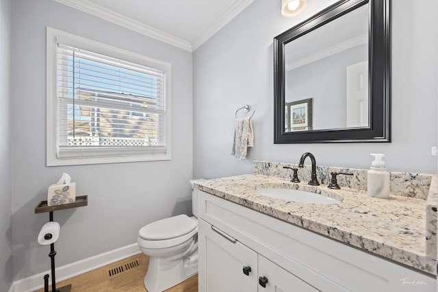 bathroom featuring hardwood / wood-style floors, vanity, toilet, and ornamental molding