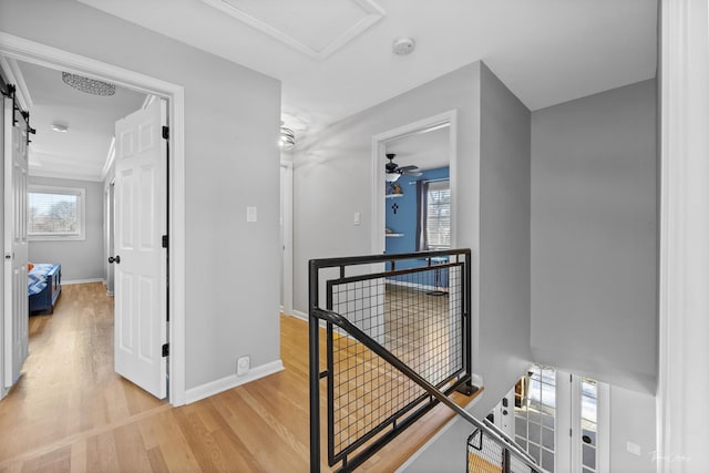 hallway with light hardwood / wood-style floors