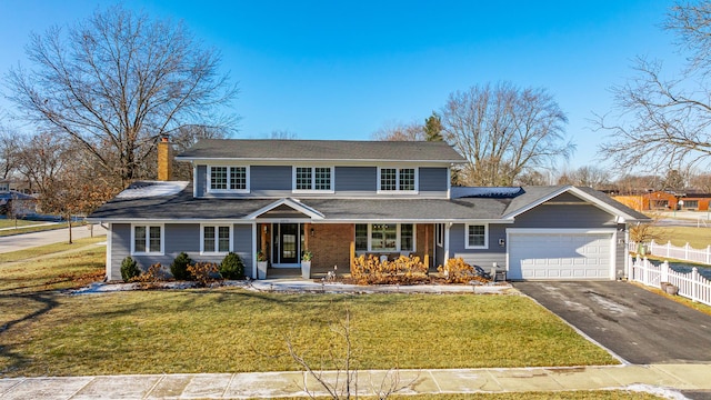 view of property featuring a front yard and a garage