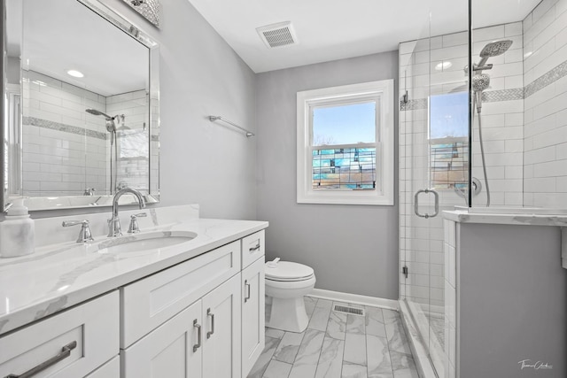 bathroom with toilet, a shower with door, and vanity